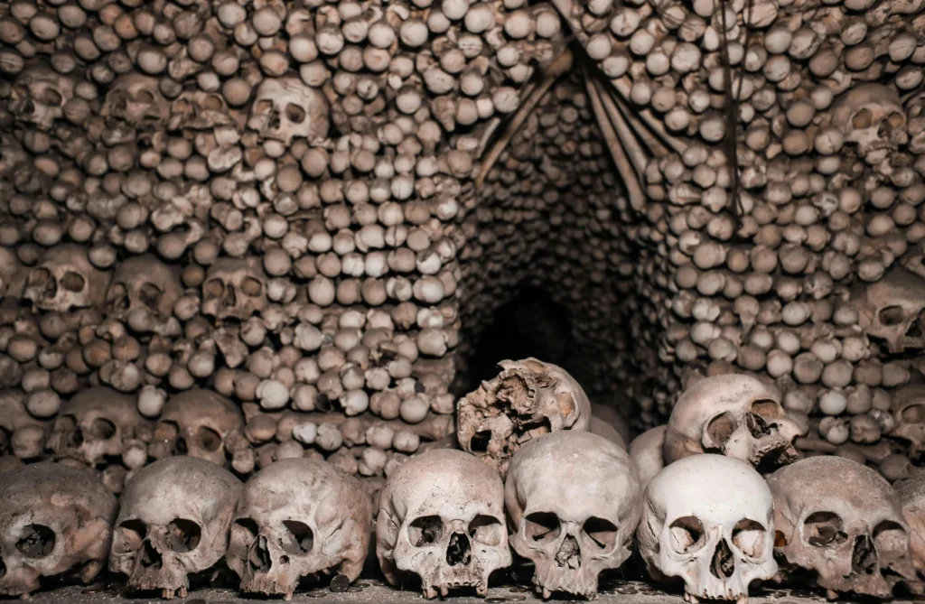Chilling scene of skulls in a catacomb, conveying a spooky and eerie atmosphere.