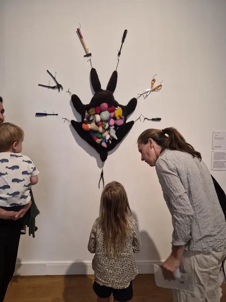巴黎狩獵自然博物館裡的 Annette Messager 特展，小孩和父母一起觀看動物玩偶雕塑